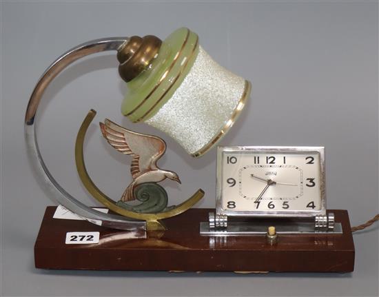 An Art Deco figural lamp / clock